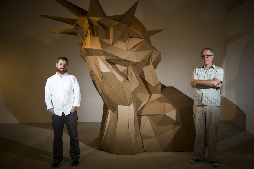 "Manifest Justice" will bring together works by more than 150 artists inspired by questions of social justice in a 10-day exhibition and series of events. Its organizer, Yosi Sergant, left, is photographed in front of "Liberty Weeps," with its artist, Joseph DeLappe.