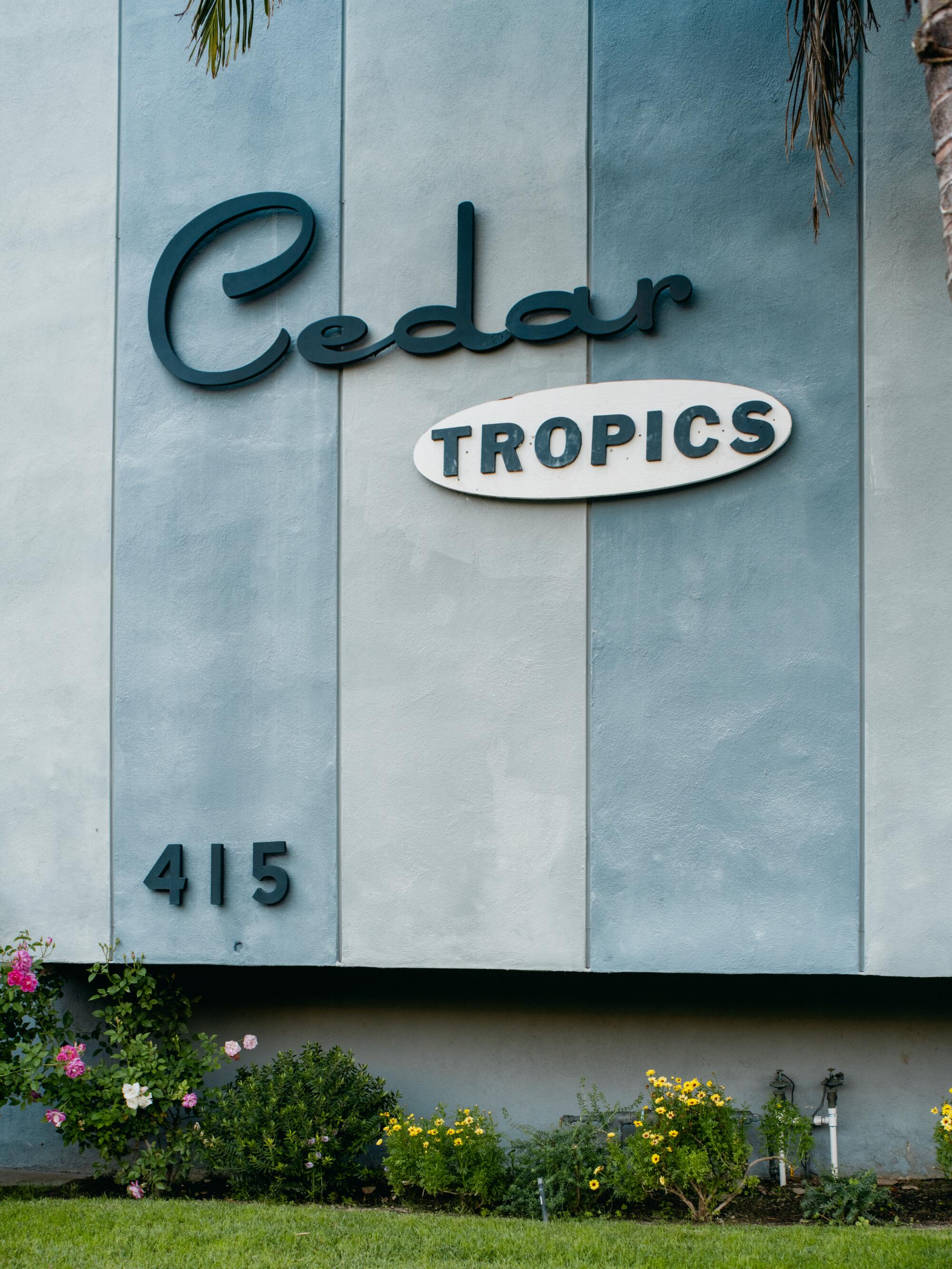 Apartment building sign that reads “Cedar Tropics 415.”