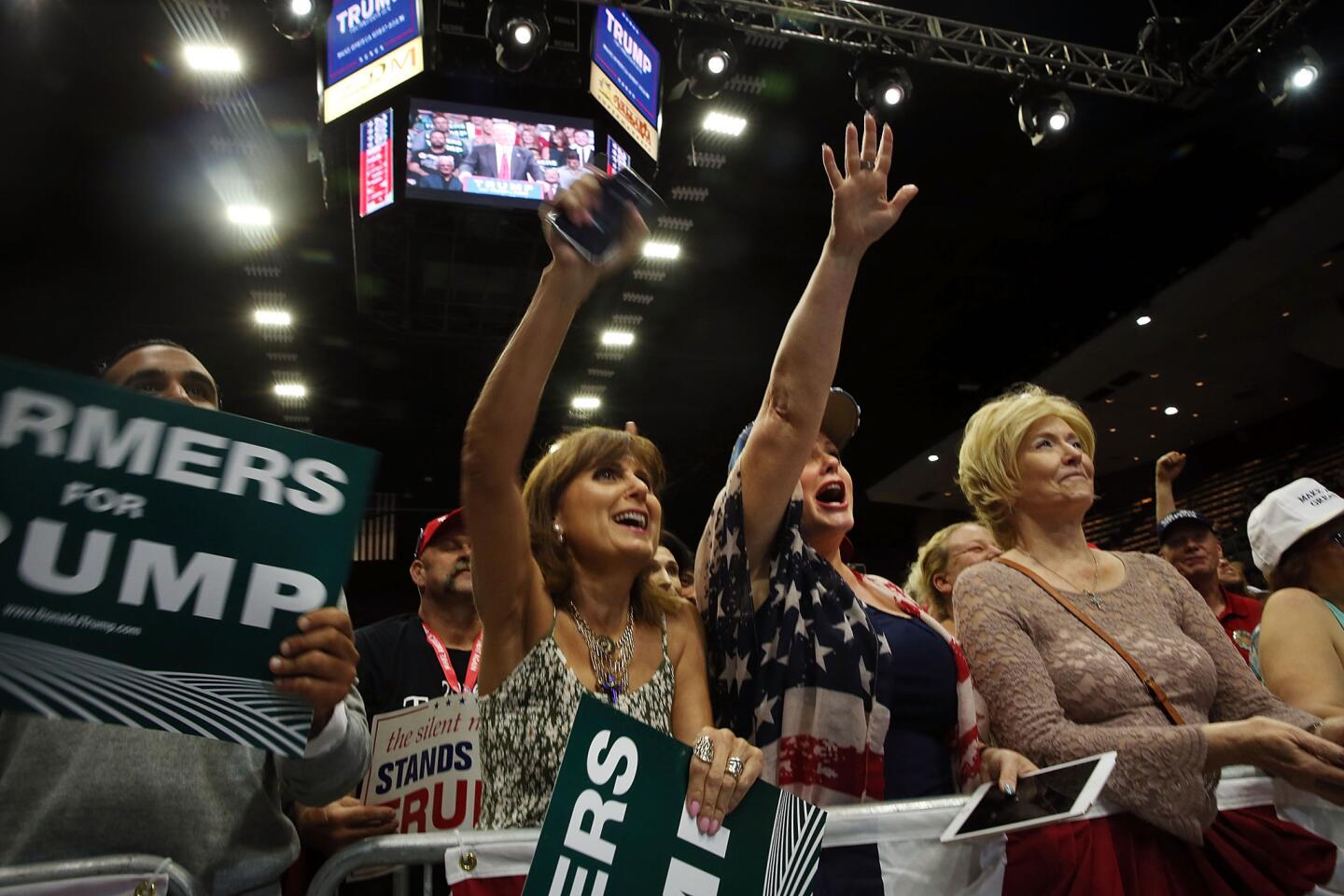 Women cheer as presumptive Republican presidential candidate Donald Trump speaks at a rally in Fresno on Friday.