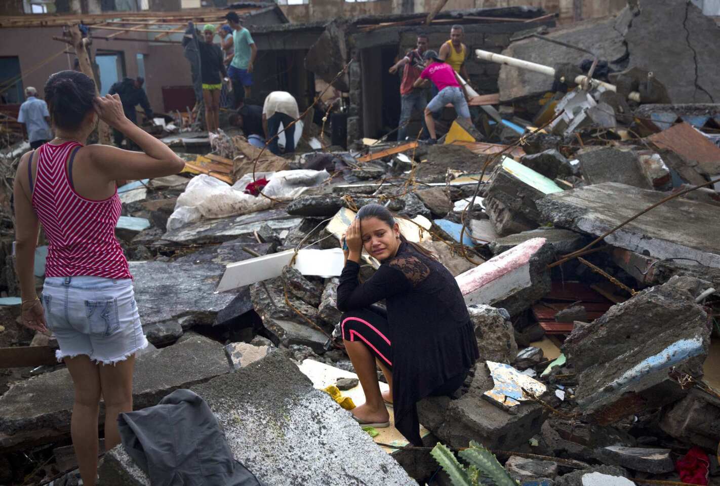 A woman cries amid the rubble of her home, destroyed by Hurricane Matthew in Baracoa, Cuba, Wednesday, Oct. 5, 2016.