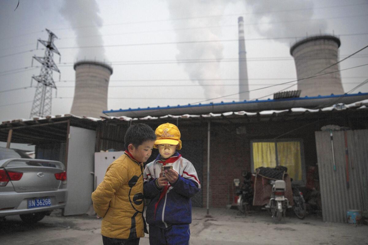 Advocates of carbon pricing argue that over the longer term, it would make coal-fired power plants, such as this one on the outskirts of Beijing, less competitive relative to wind turbines or carbon-free sources of electricity.