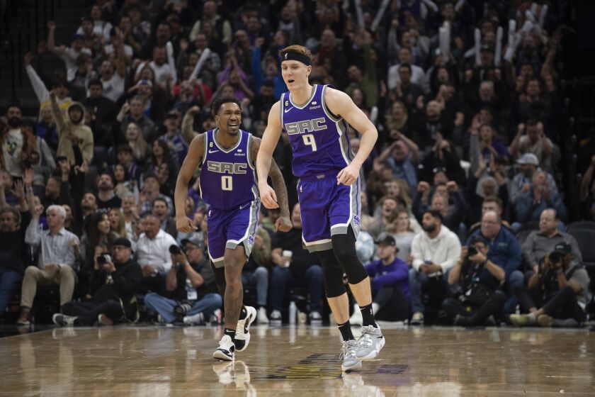 Sacramento Kings guard Malik Monk (0) yells to guard Kevin Huerter (9) after Huerter's 3-point basket against the Phoenix Suns during the second half of an NBA basketball game in Sacramento, Calif., Friday, March 24, 2023. The Kings won 135-127. (AP Photo/José Luis Villegas)