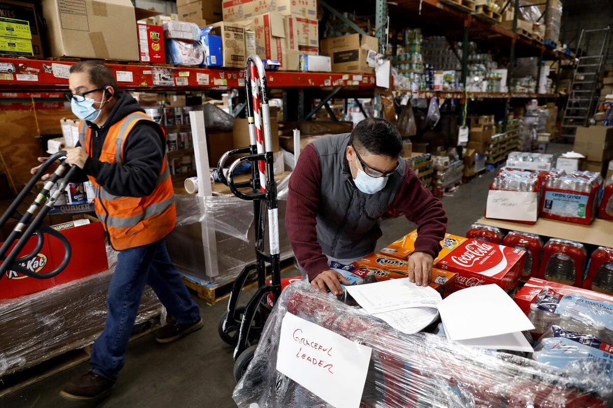 Two Harbor Ship Supply employees prepare orders for shipment.