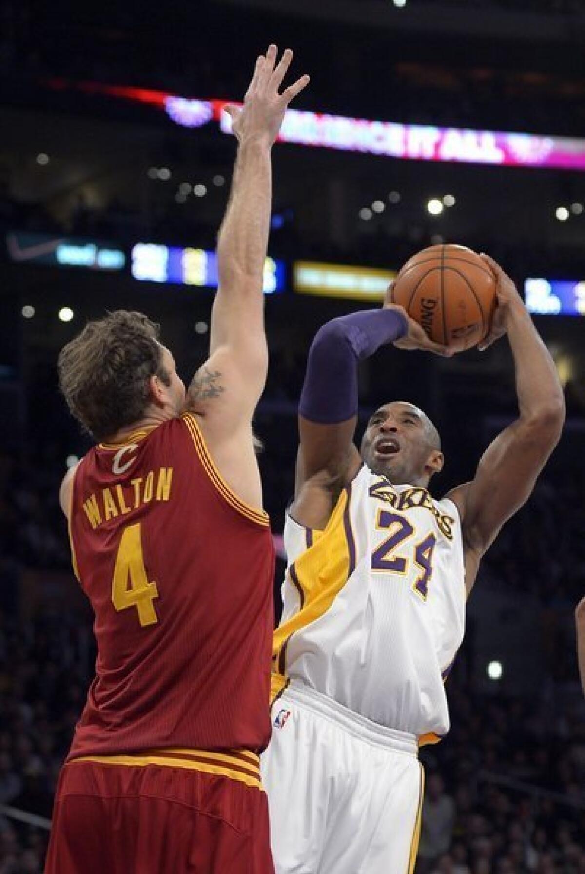 Lakers guard Kobe Bryant shoots over Cavaliers forward Luke Walton, his former L.A. teammate.