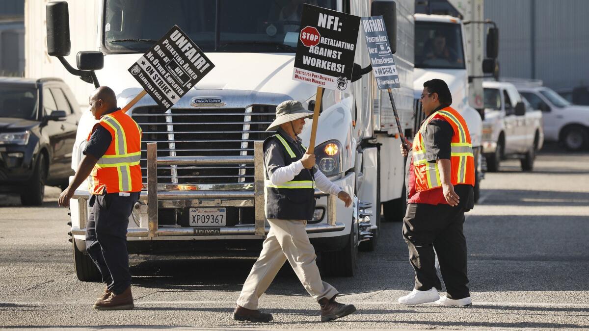 Port of Los Angeles and Long Beach truck drivers and warehouse workers protest their classification as independent contractors by XPO Logistics and NFI Industries in 2018. NFI’s Wilmington operations have been hit with seven Teamster-led strikes since 2015.