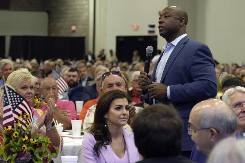 FILE - Republican presidential candidate Sen. Tim Scott, R-S.C., right, walks by Casey DeSantis, wife of GOP rival and Florida Gov. Ron DeSantis, center, as he speaks at Rep. Jeff Duncan's Faith & Freedom BBQ fundraiser on Monday, Aug. 28, 2023, in Anderson, S.C. Several campaigns are placing a huge emphasis on South Carolina, where the Republican primary is traditionally the last chance for many White House hopefuls to break through before Super Tuesday. (AP Photo/Meg Kinnard, File)
