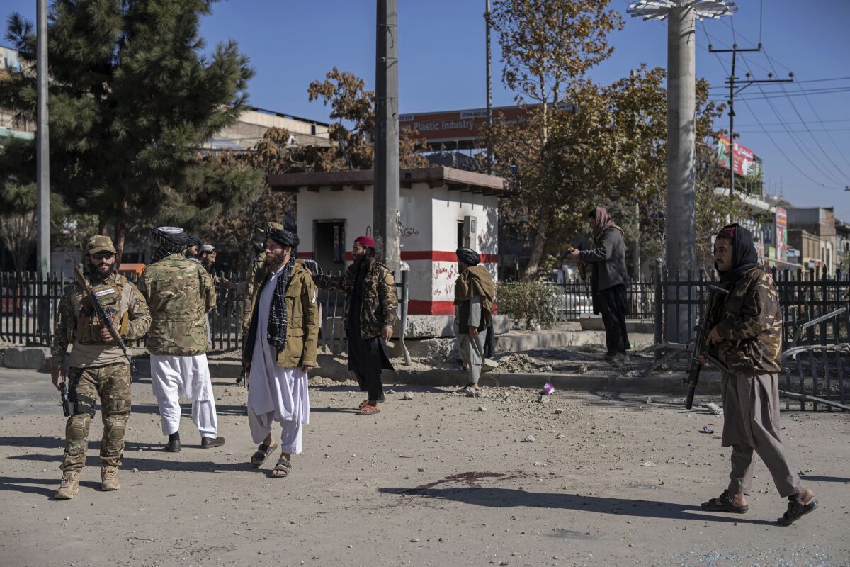 Taliban fighters secure the area after a roadside bomb went off in Kabul Afghanistan, Monday Nov. 15, 2021. The bomb exploded on a busy avenue in the Afghan capital on Monday, wounding two people, police said. (AP Photo/ Petros Giannakouris)