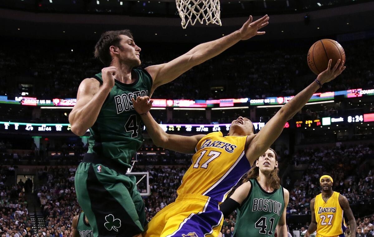 Celtics center Tyler Zeller tries to block a shot by Lakers point guard Jeremy Lin in the first half.