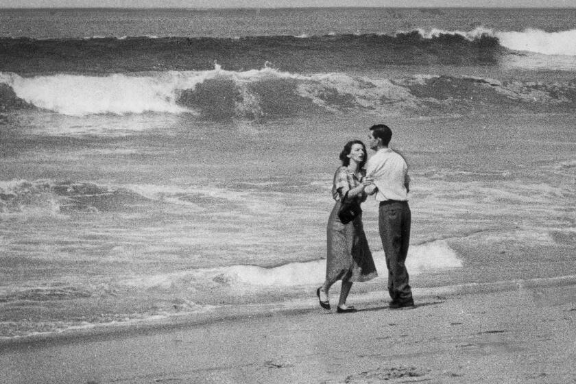 April 2, 1954: A couple are photographed moments after learning that their 19-month-old child had been swept out to sea at Hermosa Beach.