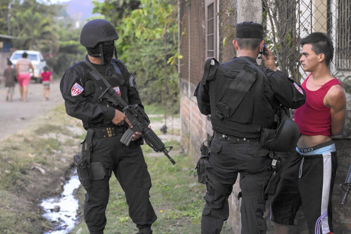 A man is detained by police special forces in San Juan Opico, El Salvador. The country has seen a fresh uptick in gang violence.