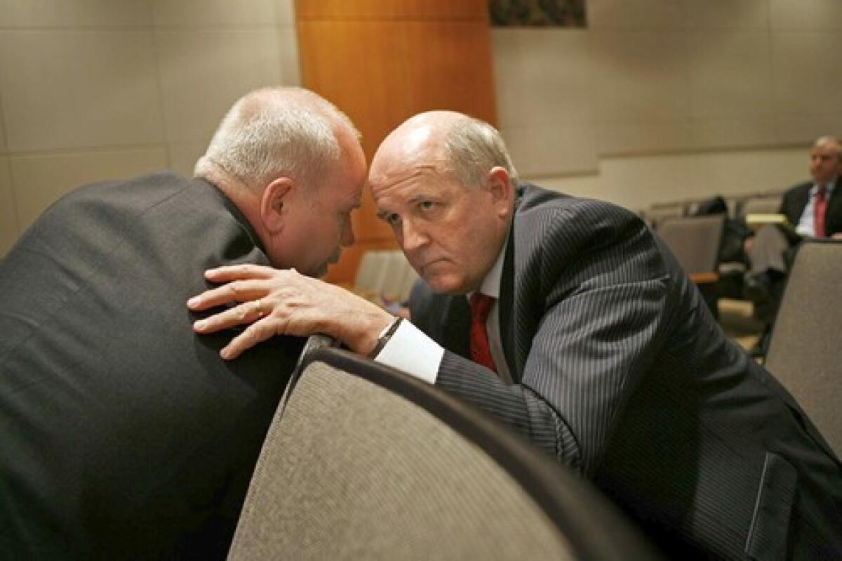 Alan Moldawer of Veolia Transportation, left, speaks with Ted Fritz of Connex Railroad during the second day of the National Transportation Safety Board hearing in Washington, D.C.