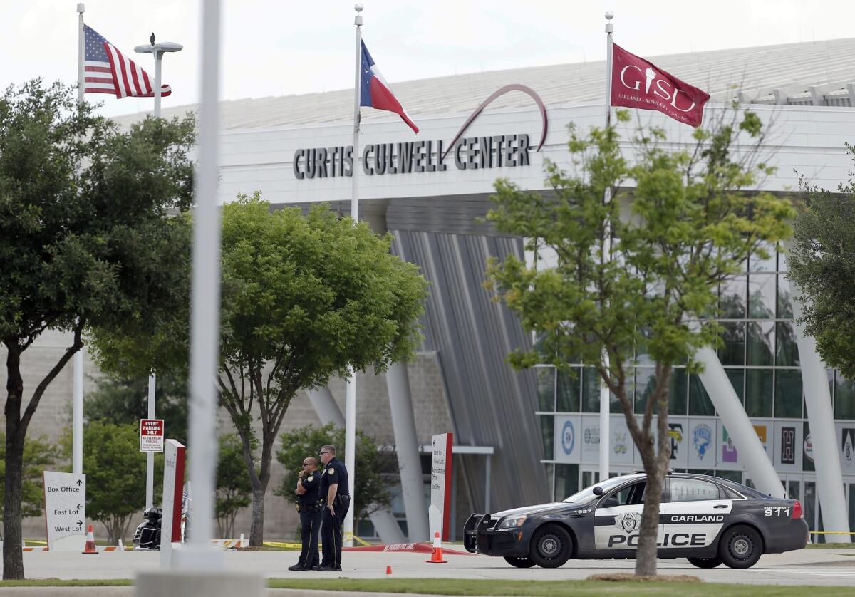 Police stand guard outside the Curtis Culwell Center on Monday in Garland, Texas. Two men who were roommated opened fire on police Sunday night who were guarding a provocative contest for Prophet Muhammed cartoons. A police officer returned fire killing both men.