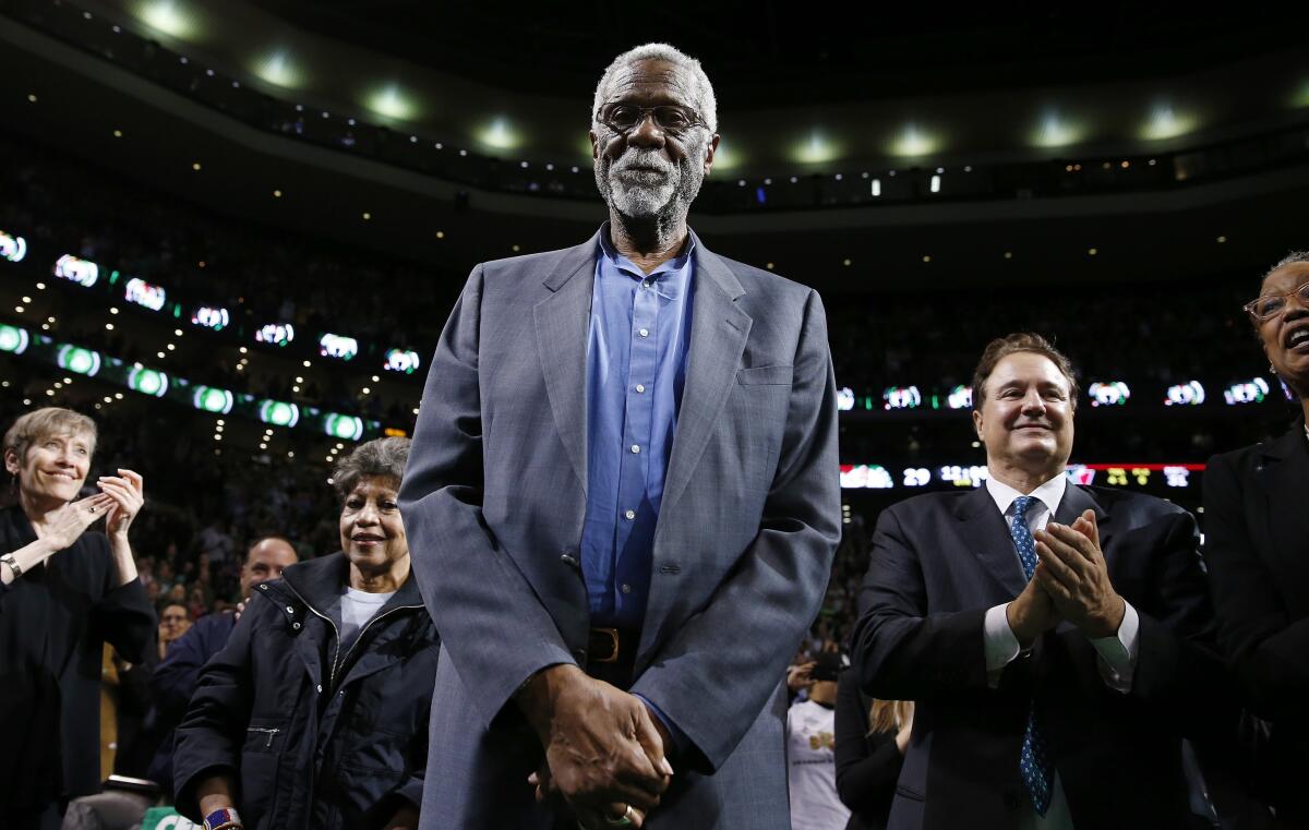 Boston Celtics legend Bill Russell stands courtside during a tribute at a game in 2013.