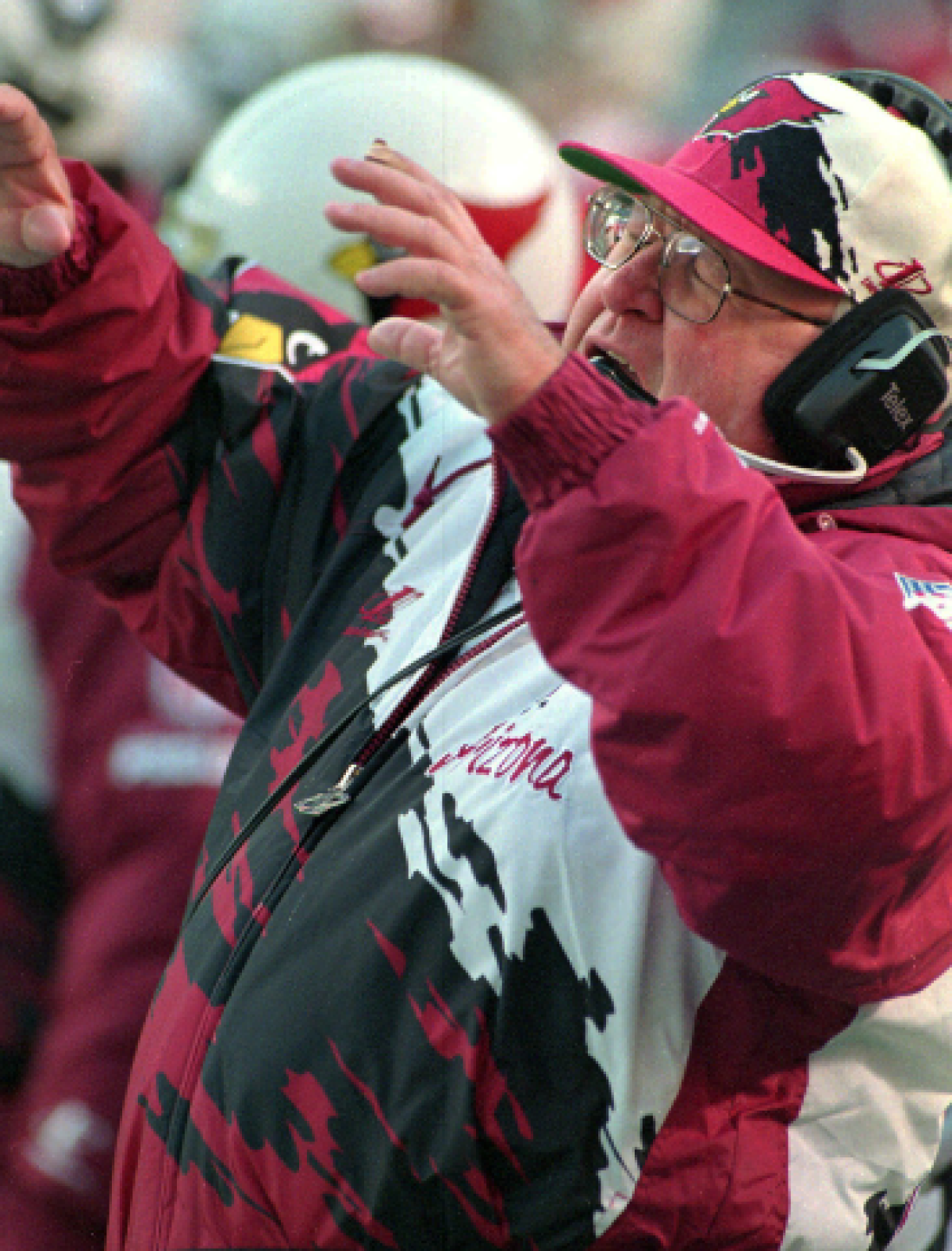 Arizona Cardinals coach Buddy Ryan holds his arms out in front of him.