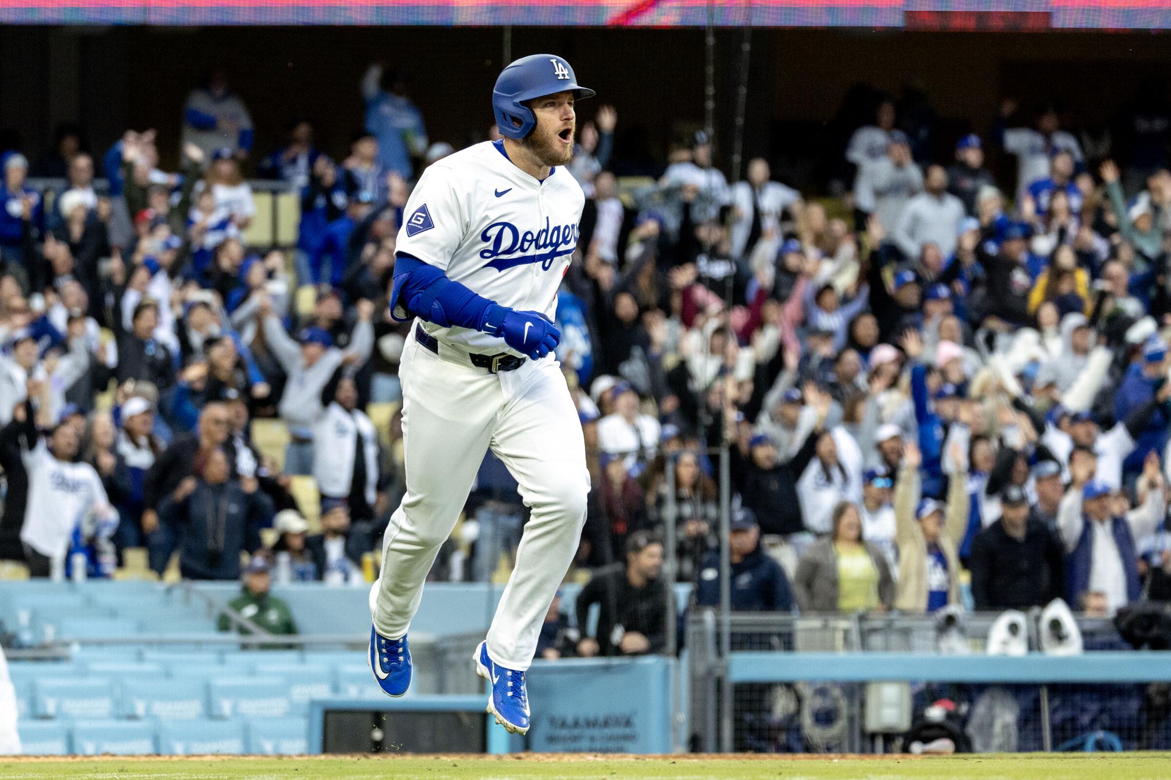Dodgers third baseman Max Muncy celebrates after hitting a two-run home run.