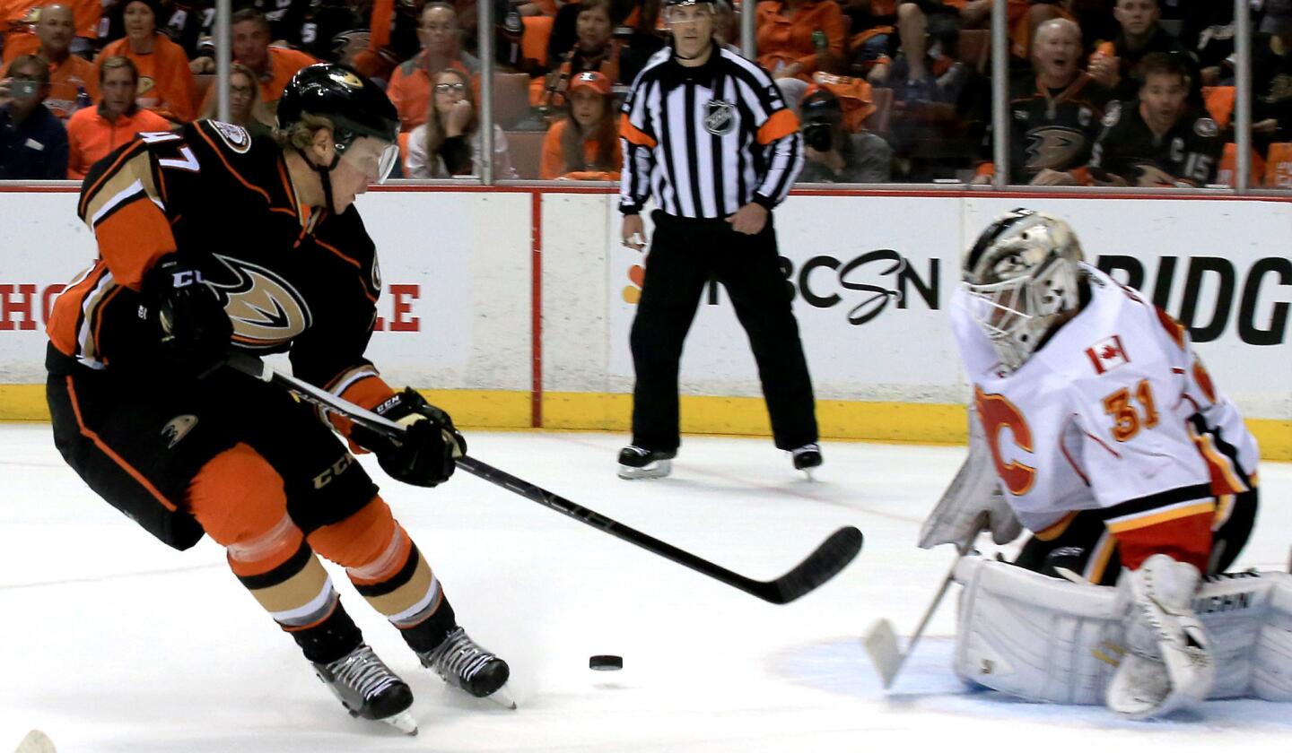 Ducks center Clayton Stoner has his shot blocked by Flames goaltender Karri Ramo in the first period of Game 2.