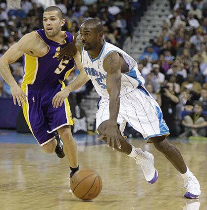 New Orleans Hornets guard Mike James tries to get past Lakers guard Jordan Farmar in the first half Wednesday night.