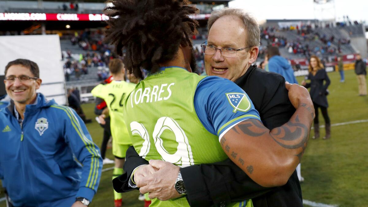 Sounders defender Roman Torres Coach Brian Schmetzer after defeating the Colorado Rapids in the second leg of the MLS Western Conference final on Sunday.