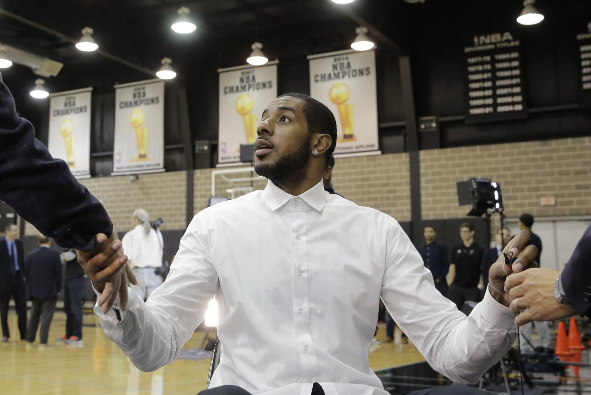 LaMarcus Aldridge talks July 10 with media after a news conference at the Spurs' practice facility, where he was formally introduced as a member of the team.