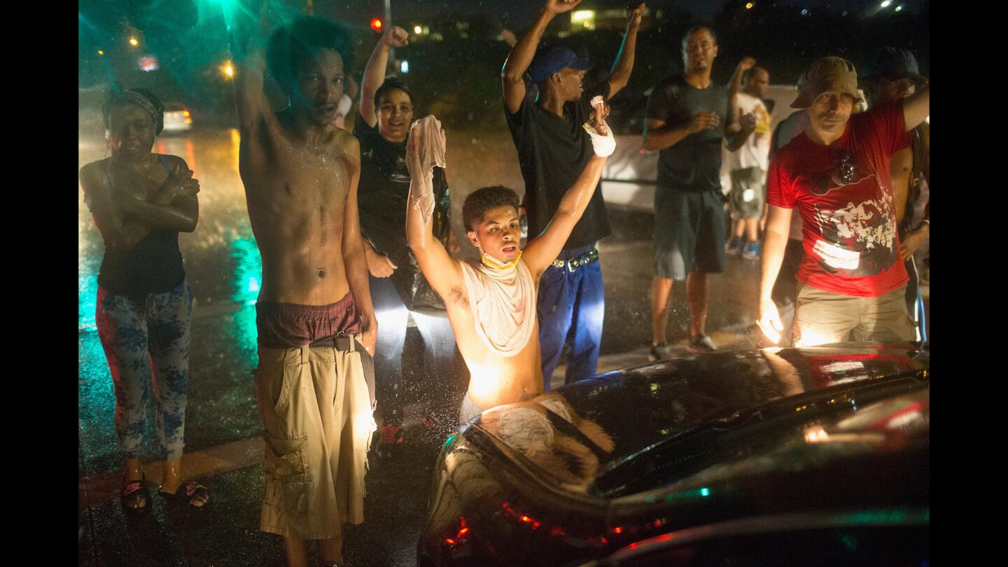 Demonstrators block traffic along West Florissant Avenue in Ferguson, Mo., on Aug. 9, 2015.