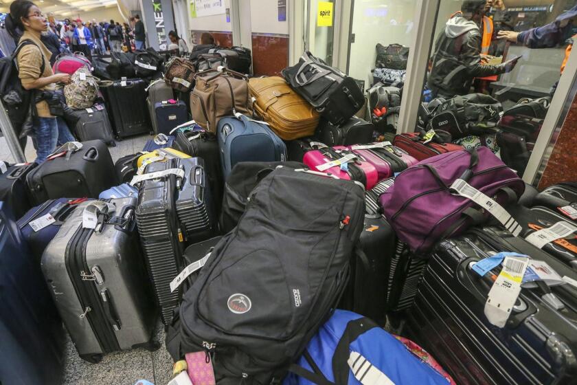 The Spirit luggage office was full of bags on Monday, Dec. 18, 2017 at Hartsfield-Jackson International Airport, the day after a massive power outage brought operations to halt. (John Spink/Atlanta Journal-Constitution/TNS) ** OUTS - ELSENT, FPG, TCN - OUTS **