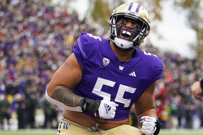 Washington offensive lineman Troy Fautanu reacts after a touchdown by running back Dillon Johnson against Utah during the first half of an NCAA college football game Saturday, Nov. 11, 2023, in Seattle. (AP Photo/Lindsey Wasson)