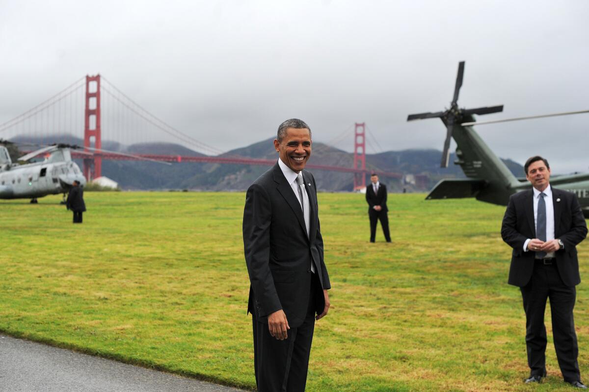 President Obama smiles before boarding the Marine One helicopter in a field overlooking the Golden Gate Bridge in San Francisco on Thursday.