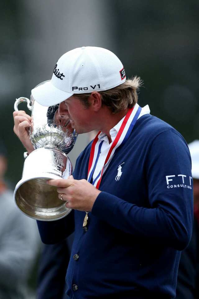 Webb Simpson kisses his trophy after winning his first major title at the U.S. Open.