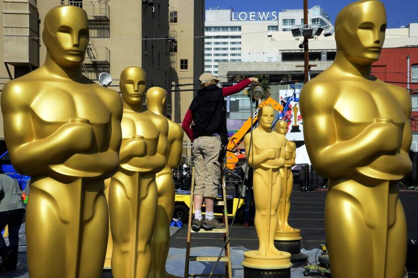 Oscar statues stand in Hollywood before the 2015 Academy Awards.