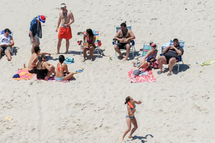 FiLE - In this Sunday, July 2, 2017 file photo, New Jersey Gov. Chris Christie, right, uses the beach with his family and friends at the governor's summer house at Island Beach State Park in New Jersey. New Jersey Gov.-elect Phil Murphy is getting some pushback for posing for photos on Thursday, Dec. 14, 2017, next to a cardboard cutout of Christie lounging on a beach last summer. Christie came under intense criticism for using the beach closed to the public over the Fourth of July weekend due to a government shutdown. (Andrew Mills/NJ Advance Media via AP)