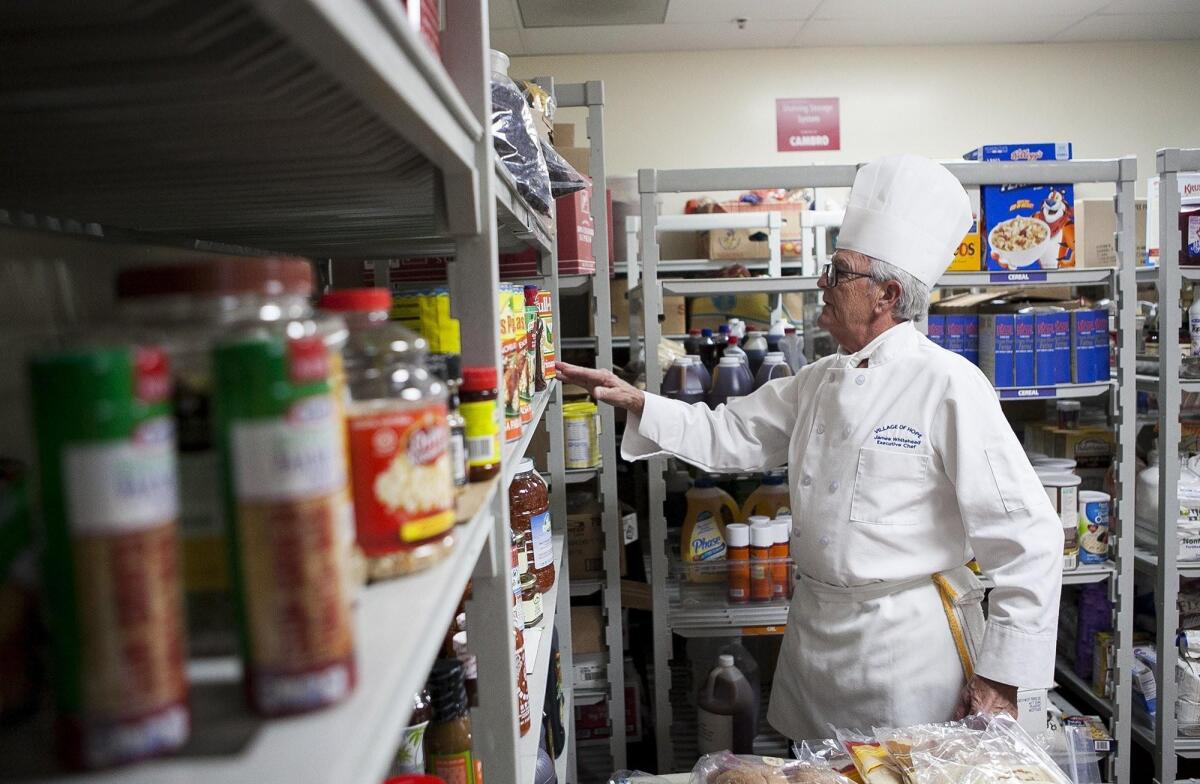 Newport Beach resident James Whitehead, 71, looks in the pantry at the Orange County Rescue Mission in Tustin, where he recently celebrated five years and more than 800 hours of service as a chef.