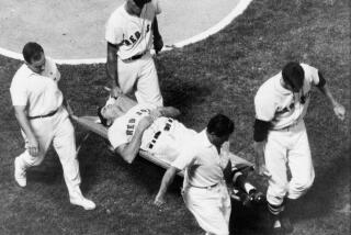 Boston Red Sox outfielder Tony Conigliaro is carried off the field on a stretcher by teammates and the trainers of both the Red Sox and the California Angels after he was beaned by Angels pitcher Jack Hamilton in the fourth inning of their game at Fenway Park in Boston, Mass., Aug. 18, 1967. The star player has been hospitalized with a severe concussion and eye injury. (AP Photo/Bill Chaplis)