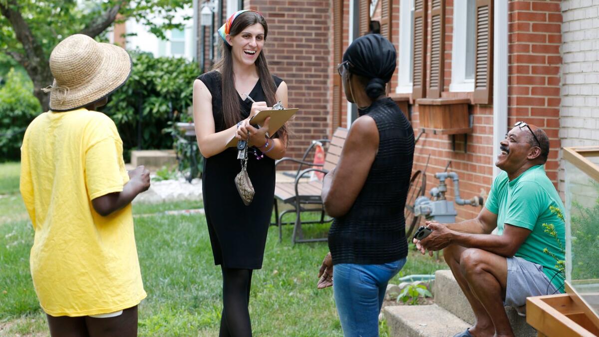 Danica Roem, second from left, talks with voters as she canvasses a Manassas, Va., neighborhood in June.