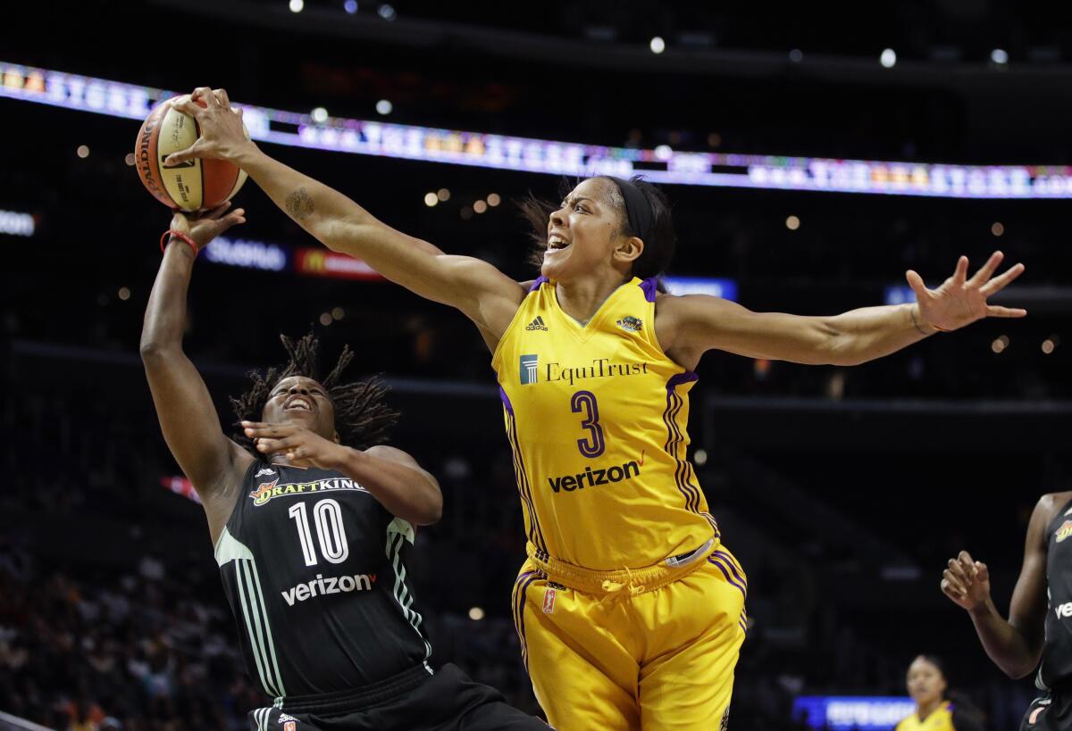 Candace Parker, right, blocks a shot by New York's Epiphanny Prince while playing for the Sparks in 2017.