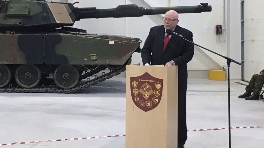 In this Dec. 15, 2016 photo, U.S. Ambassador to Estonia James D. Melville Jr. addresses dignitaries in front of a U.S. Army tank, at a hand-over ceremony of the upgraded NATO military base in Tapa, Estonia.