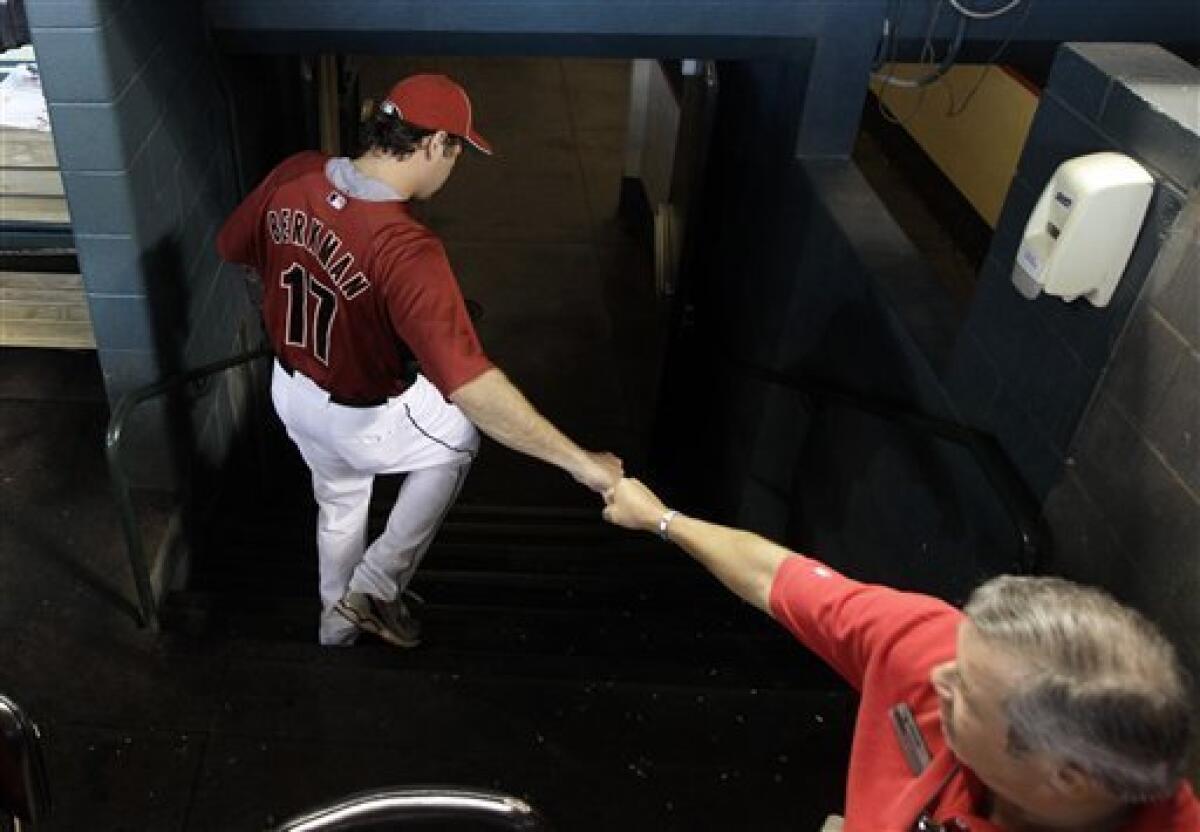 Houston Astros' Lance Berkman walks back to the dugout after