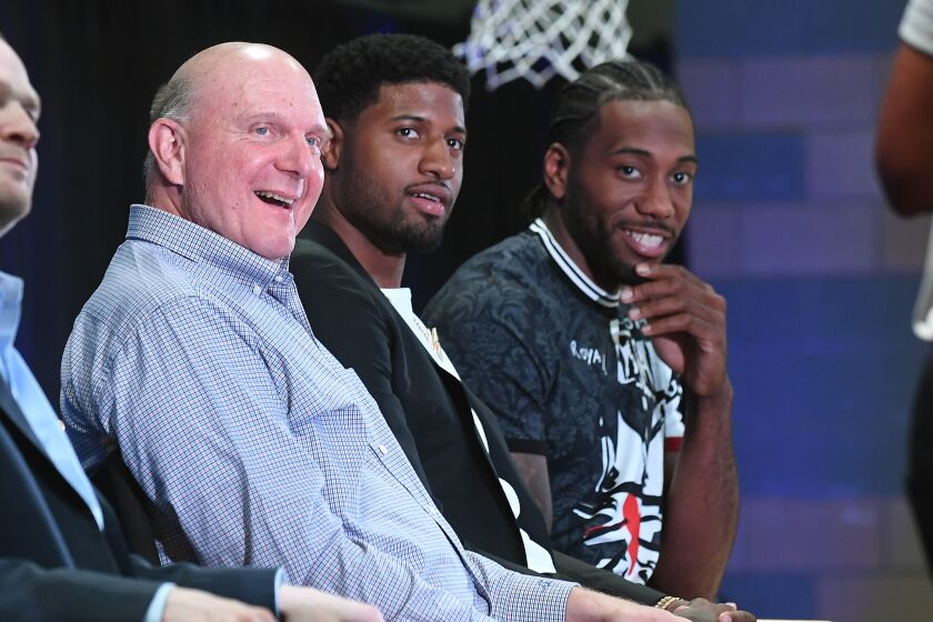 LOS ANGELES, CALIFORNIA JULY 24, 2019-Clippers owner Steve Balmer with new players Paul George, center, and Kawhi Leonard at Green Meadows Recreation Center in Los Angeles Wednesday. (Wally Skalij/Los Angeles Times)