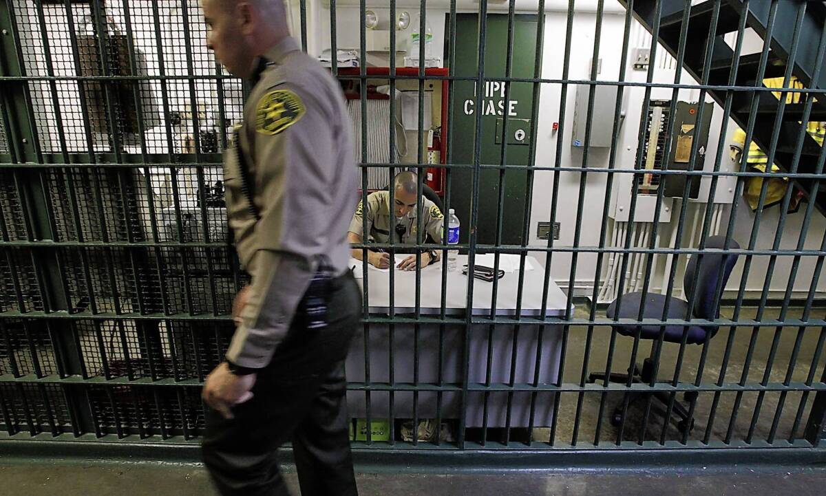 Deputies work in a secure section of the Men's Central Jail. As many as 70% of all inmates in the county’s roughly 23,600-bed jail system are addicted to drugs or suffer from mental illness, according to estimates.