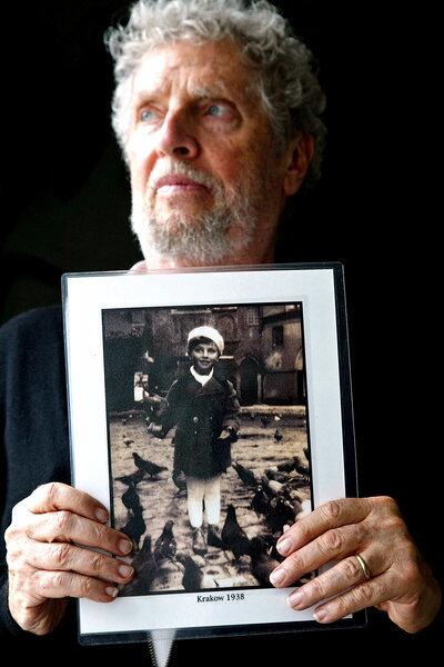 Leon Prochnik holds a photo of himself as a 6-year-old child in Krakow, Poland, at the Los Angeles Museum of the Holocaust. Leon had just spoken to students from Fillmore High School and Fillmore Middle School about how his family fled when the Nazis invaded.