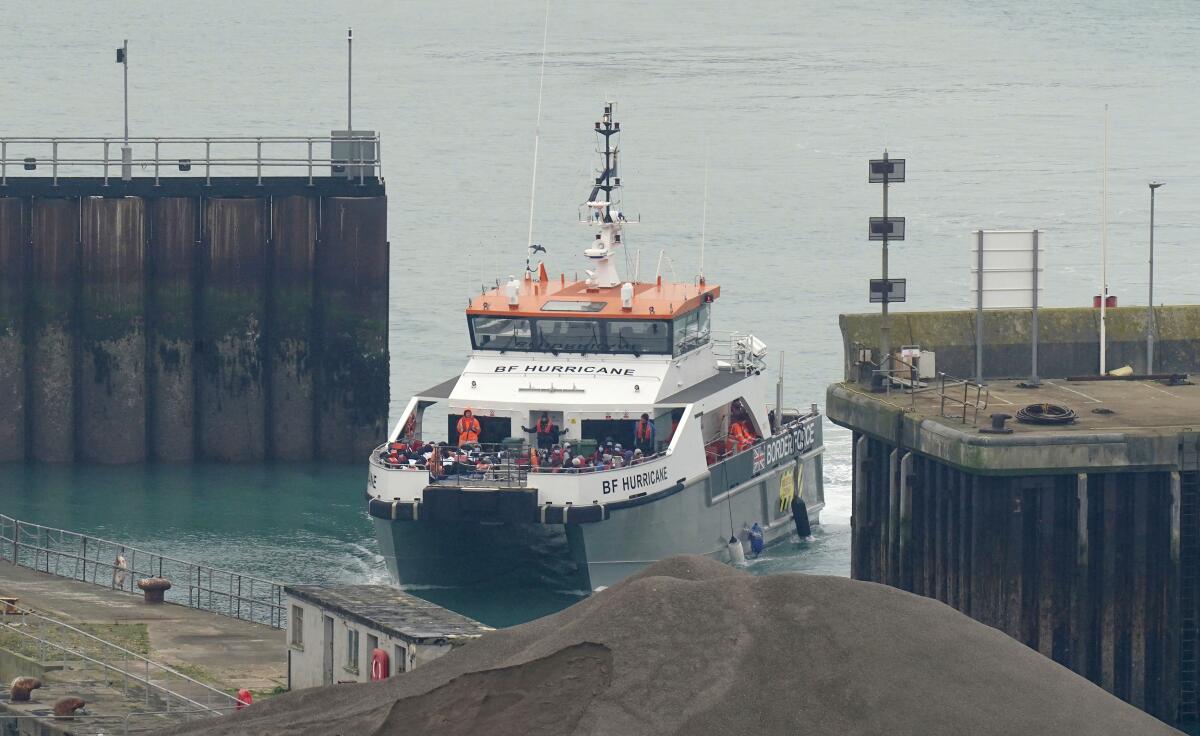 A British Border Force vessel carrying a group of people thought to be migrants comes in to dock in Dover, England.