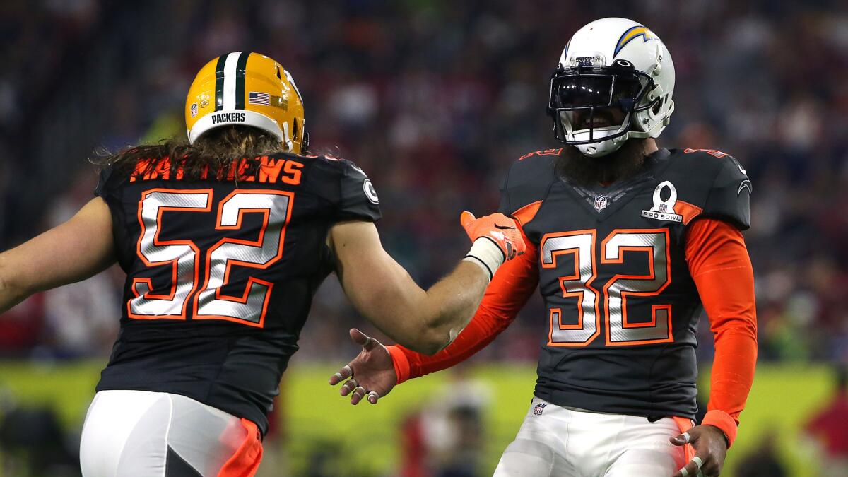 Team Irvin safety Eric Weddle, right, congratulates linebacker Clay Matthews during the Pro Bowl in Glendale, Ariz., on Jan. 25.