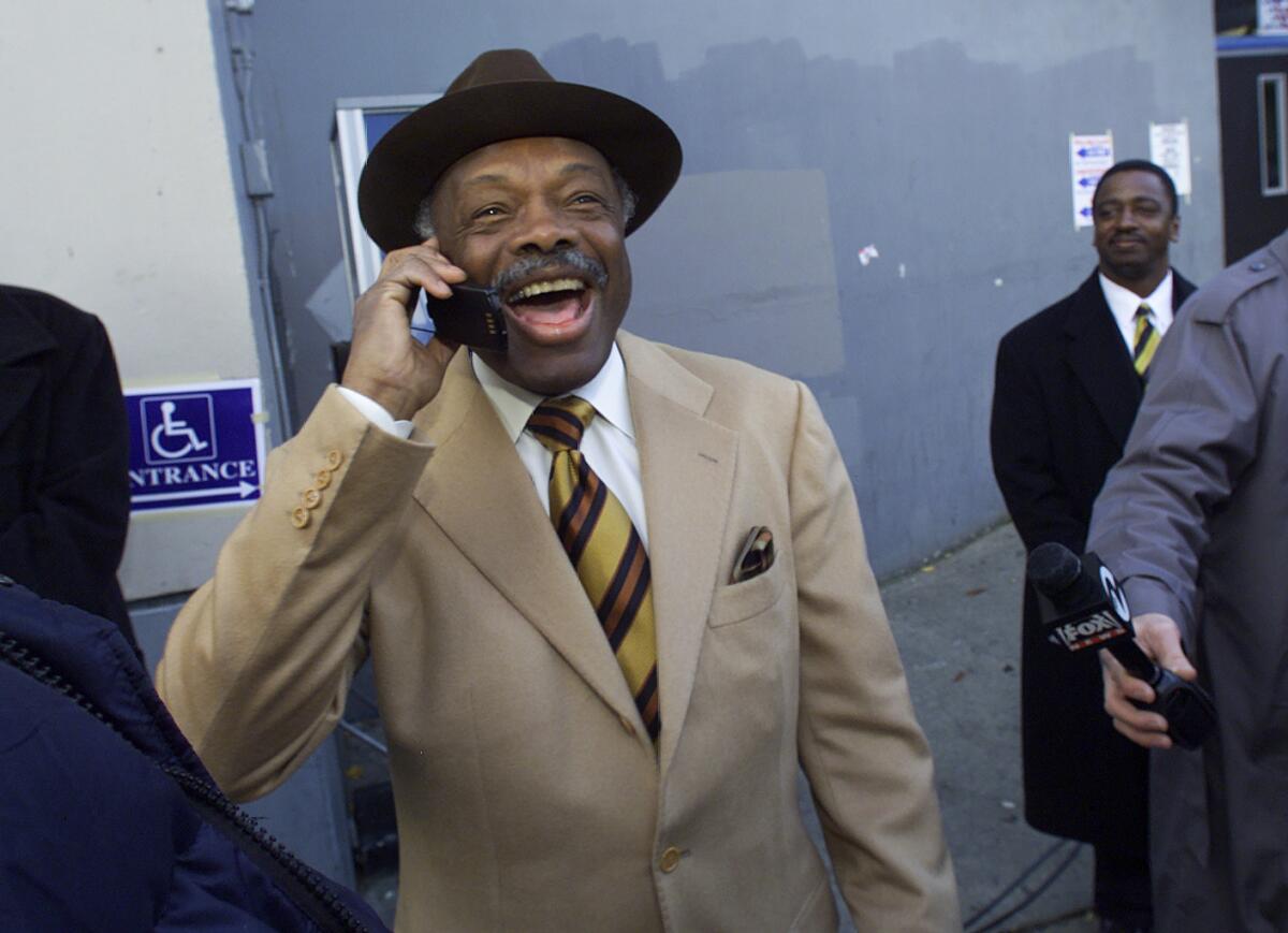 Mayor Willie Brown places a call after casting his early morning vote.