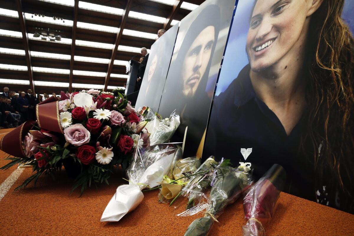Photos of French sailor Florence Arthaud, boxer Alexis Vastine and swimmer Camille Muffat are displayed during a ceremony for them at the Institut National du Sport in Paris.