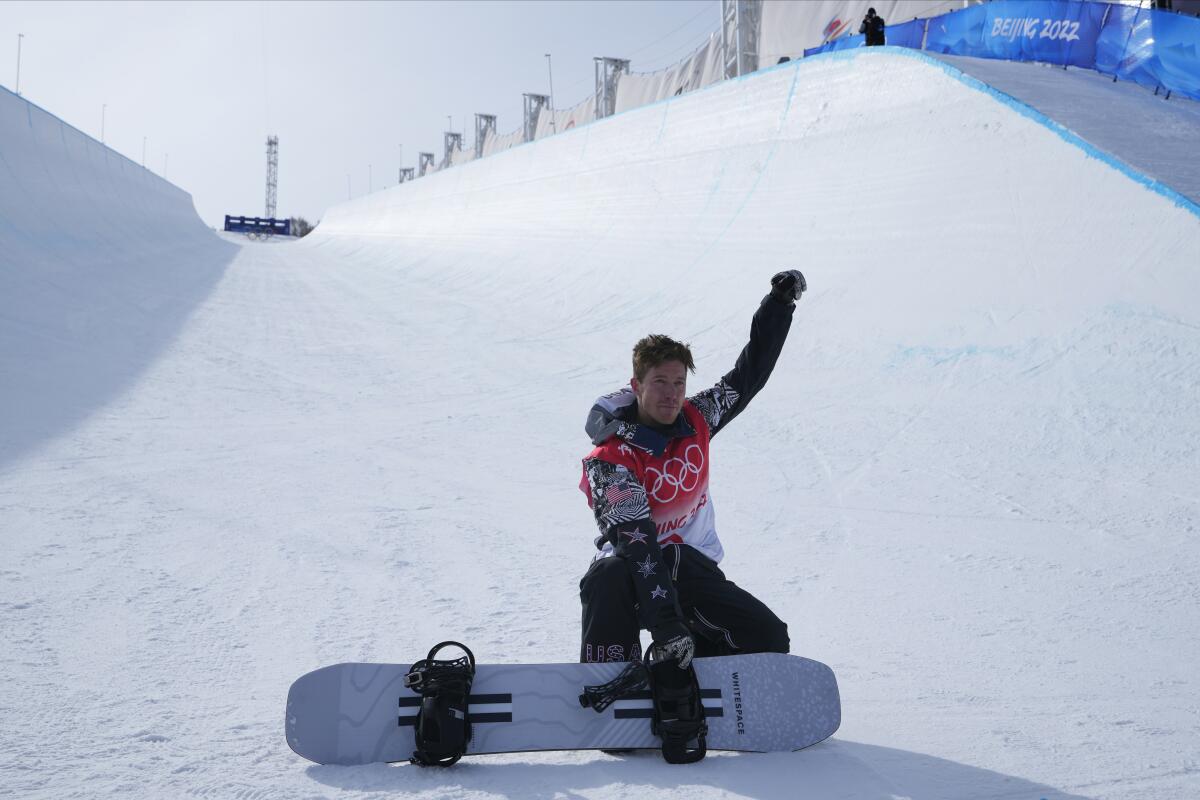 FILE - Shaun White poses in the halfpipe course after the men's halfpipe finals at the 2022 Winter Olympics