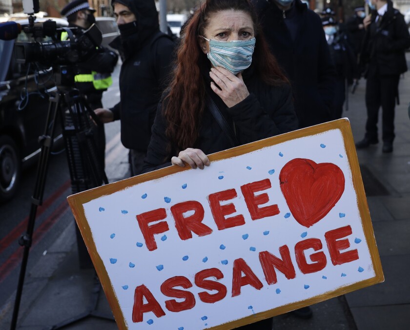 A Julian Assange supporter reacts outside the Westminster Magistrates Court after Julian Assange was denied bail at a hearing in the court in London, Wednesday, Jan. 6, 2021. On Monday Judge Vanessa Baraitser ruled that Julian Assange cannot be extradited to the US. because of concerns about his mental health. Assange had been charged under the US's 1917 Espionage Act for "unlawfully obtaining and disclosing classified documents related to the national defence". Assange remains in custody. (AP Photo/Matt Dunham)