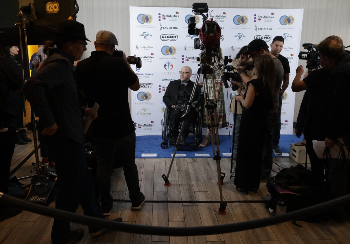 Michael Dougherty, Reelabilities Film Festival co-director, arrives on the “blue carpet” during the kickoff for the three-day event at Universal Cinema.