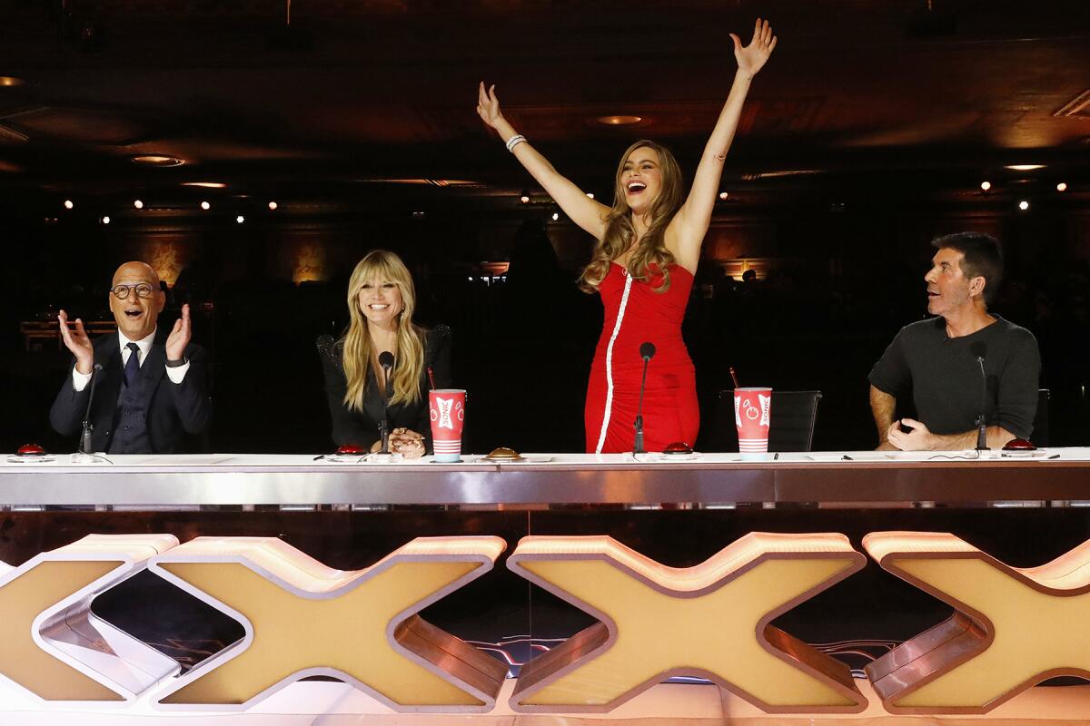 Howie Mandel, left, Heidi Klum, Sofia Vergara and Simon Cowell react while at the judges table on "America’s Got Talent." 