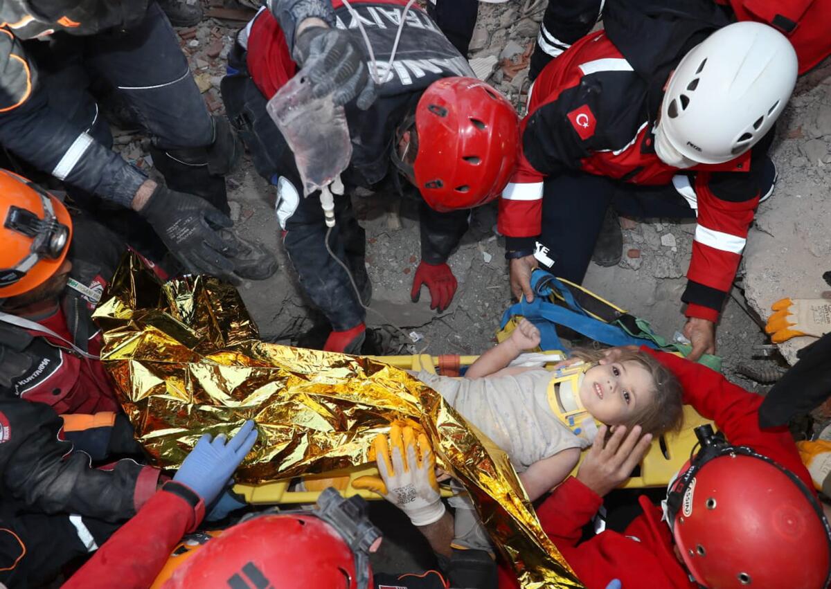 Rescue workers find Ayda Gezgin in the rubble of a collapsed apartment building in Izmir, Turkey.
