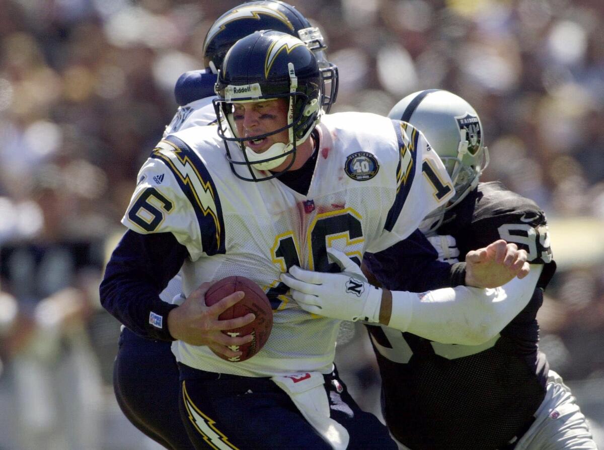 San Diego Chargers quarterback Ryan Leaf is sacked by Oakland Raiders defensive end Josh Taves during a Sept. 3, 2000, game in Oakland.