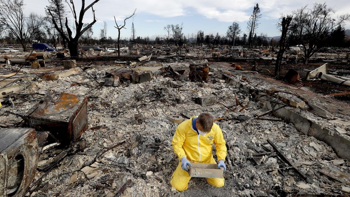 A Coffey Park man combs through the remnants of his home after the Tubbs fire swept through his neighborhood in October 2017.